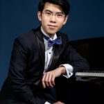 Portrait of Aristo Sham seated at a Piano
